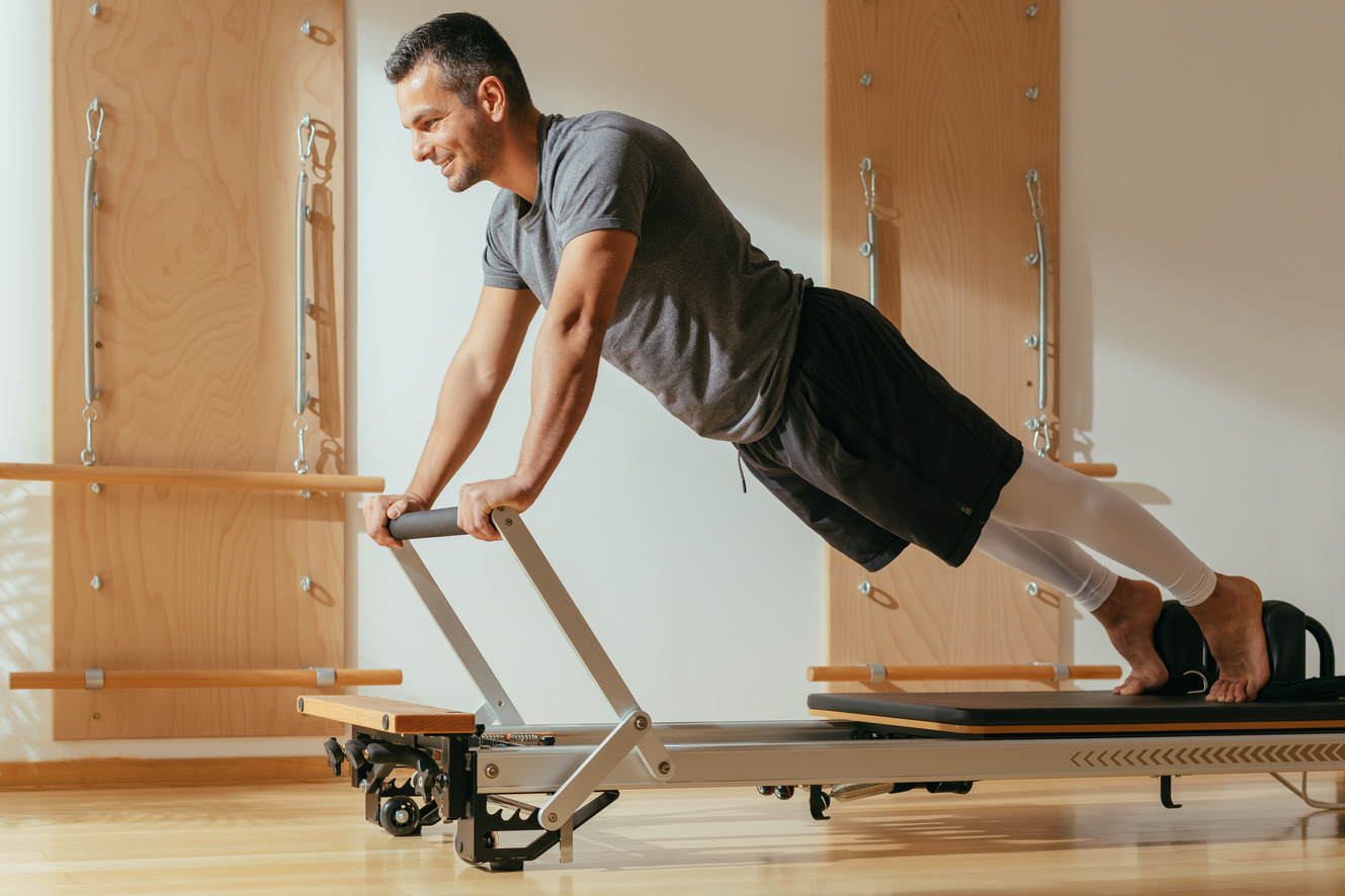 A Man Doing Reformer Pilates